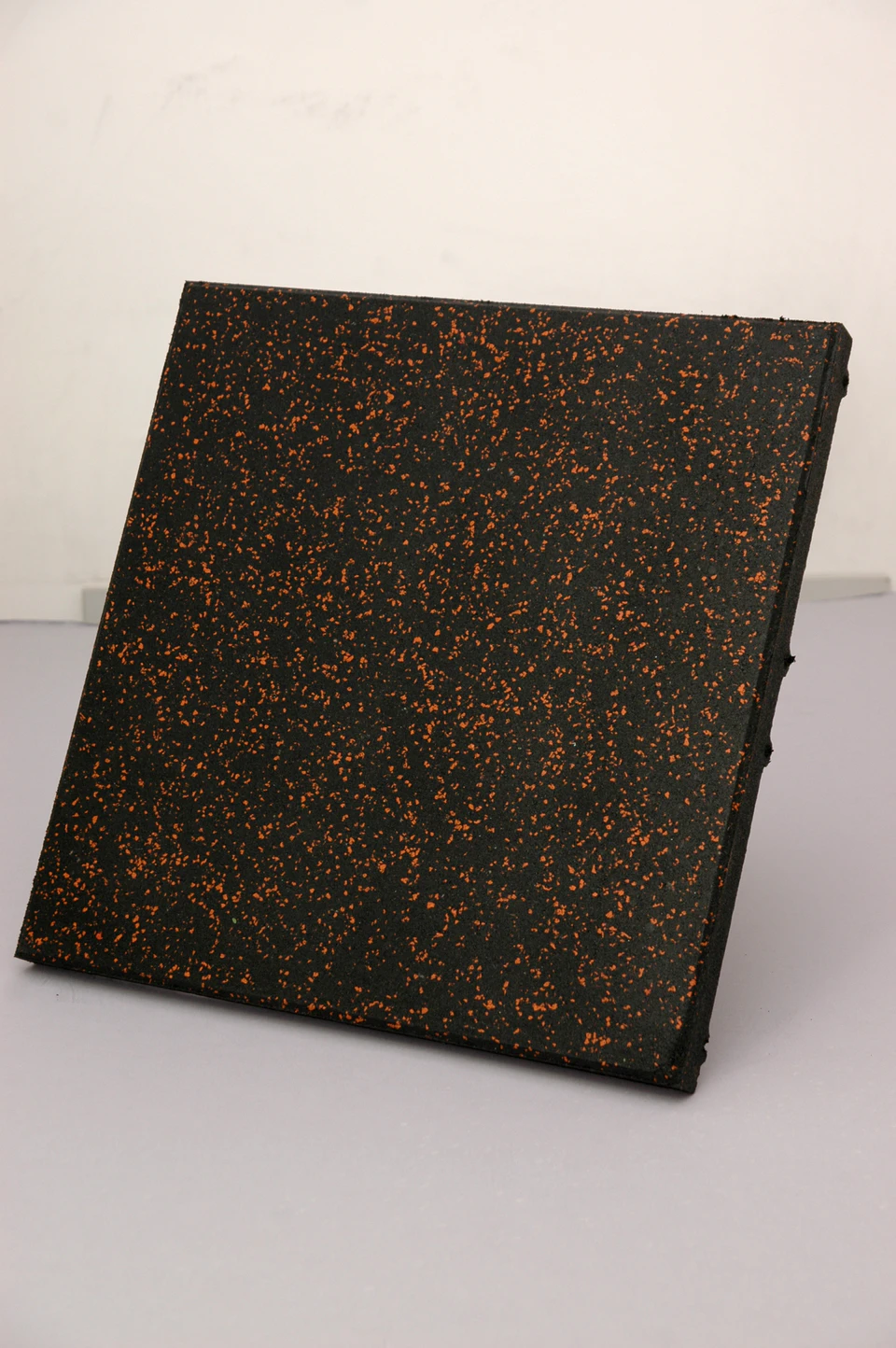 Black recycled rubber tile with orange fleck